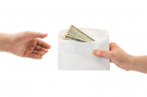 Hands and money in envelope - iStock